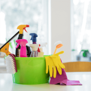 Bucket of cleaning supplies lying on a table--child care