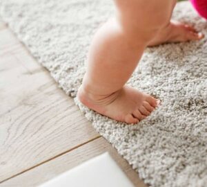Baby standing on a carpet