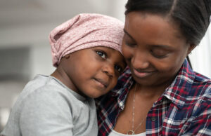 Woman holding and smiling at child