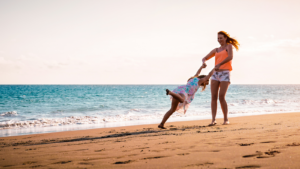 Mother and Daughter Having Fun on Tropical Beach
