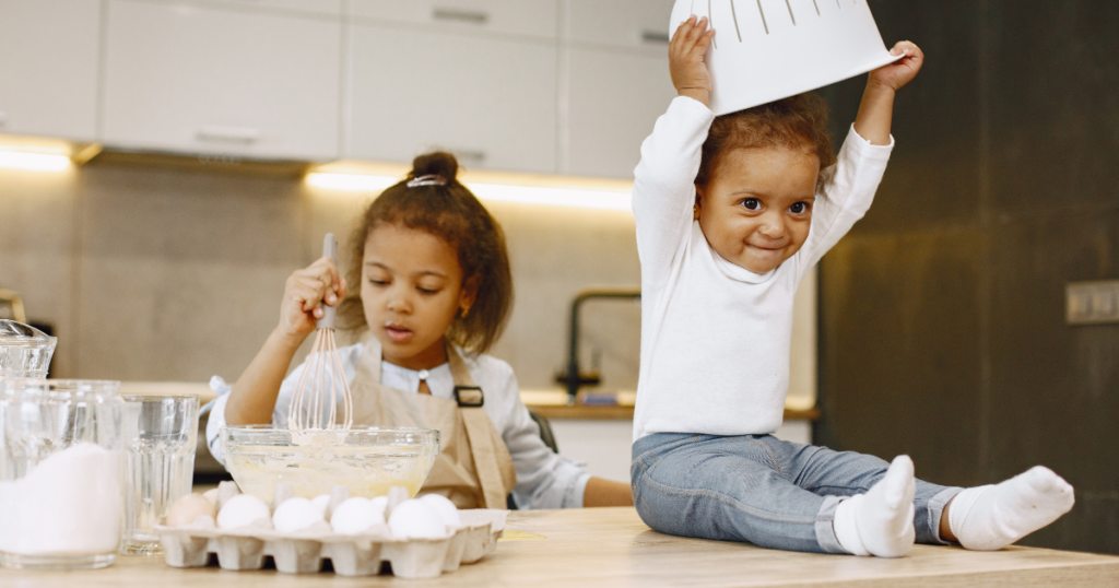 Two small children mix eggs into batter in a kitchen--- PFAS in Child Care