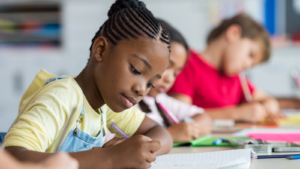 Young girl writes in a classroom-- Alabama children's environmentalhealth