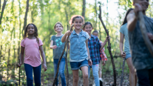 A diverse group of children walk in the woods--Arkansas children's environmental health