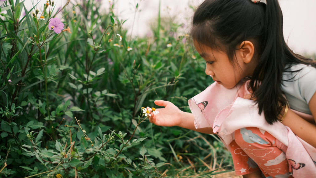 Child examining flower - Idaho children's environmental health