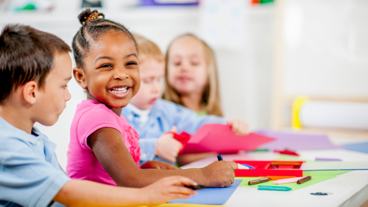 Children sitting at a table and coloring - Massachusetts children's environmental health