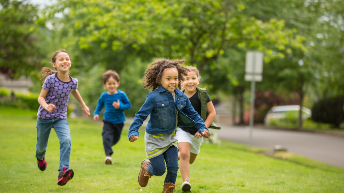 Children running across grass - New Mexico children's environmental health