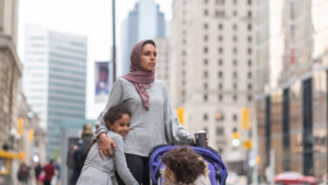Woman with two children on city sidewalk - New York children's environmental health