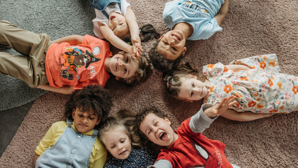 Seven children lying down in a circle -- Utah children's environmental health