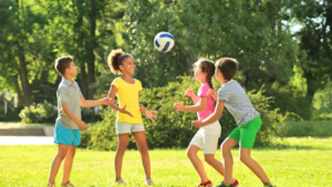 Four children playing outside with a ball -- Wisconsin children's environmental health
