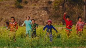 A group of children running in a grassy field -- Wyoming's children's environmental health