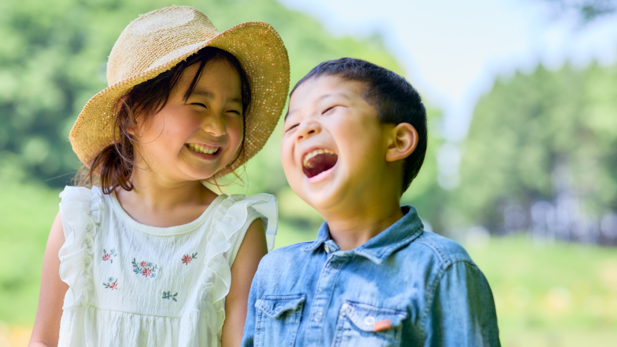 Two children standing outside laughing - North Carolina children's environmental health