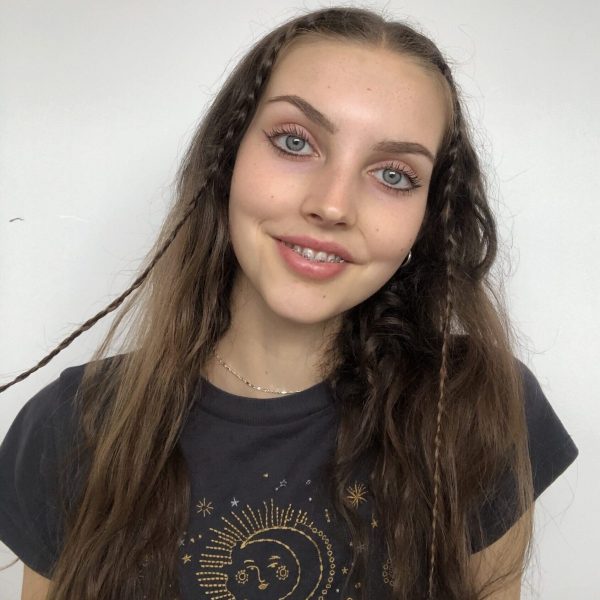 Rebecca Barry smiles at the camera in front of a white background